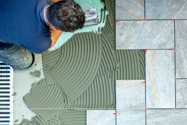 spreading-with-trowel-floor-glue-view-from-above-2025-03-23-20-28-14-utc_5_11zon